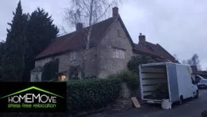 HomeMove relocation van parked outside a large stone house during a move