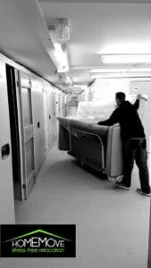 HomeMove worker moving a sofa into a secure storage facility