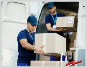 Professional movers unloading boxes from a moving van
